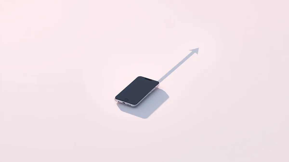 Illustration: A single sleek smartphone rests on a polished surface, casting a long shadow that forms a sharp upward arrow.